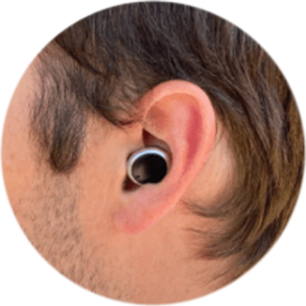 An earbud-style hearing device worn in an ear